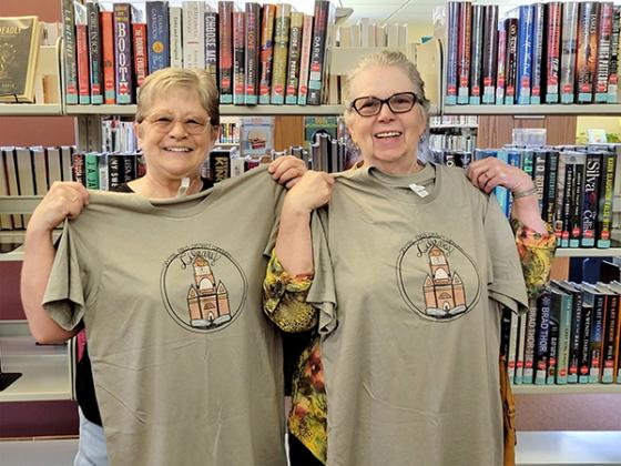 Fleurette Saari and Peggy Padilla pose with their prize for being the winners of the Crystal Falls Library Bingo Challenge. (submitted photo)