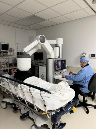 Dr. Medhat Fanous uses the control panel of the NaviCam Stomach System to magnetically direct the camera capsule inside of patient Nancy Schauwecker’s stomach. (Photo courtesy: Kate Collins) 