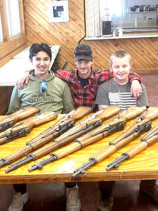 Pictured are, from left, Alexander Erickson (STSC Youth Club President), Thomas Taff (NRA Instructor) and Bo Glasheen (Youth Club Vice President).  In front of them are some of the many M1 Garand Rifles they cleaned.  (submitted photo)