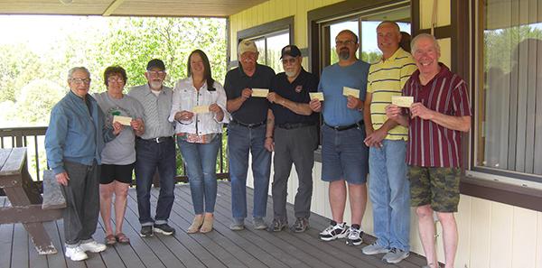 From left, Sec-treas. Art Aregoni presents $450 for the Duke of Abruzzi Building Restoration Fund to volunteers Debbie Bomaster & Robert Ketchum, and $200 to Kathi Long. Director of the Iron County Historical Museum; Member Robert Remondini presents $100 to Michael Peterson, representing the West Side Veterans Fireworks Program; President Mark Stauber presents $1000 to City Manager John Stokoski; & $100 for the Caspian-Gaastra Fireman's children party. Jim Paul presents $150 for the Caspian Police K-9 Fund.