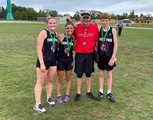 Pictured are, Forest Park Coach DJ Rasner, with Lilly Post, Tatum Clark and Reuben Rasner. Submitted photo