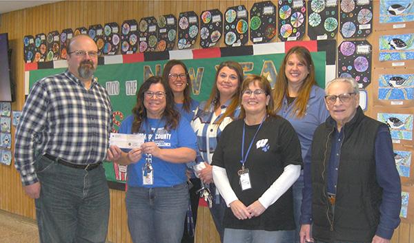 Pictured are, from left, Mark Stauber (Grand Knight), Lisa Anderson, Jen Schive, Jodi Fales, Kris Bristol, Theresa Heirmerl (teachers) and Art Aregoni (Tootsie Roll Drive Chairman).