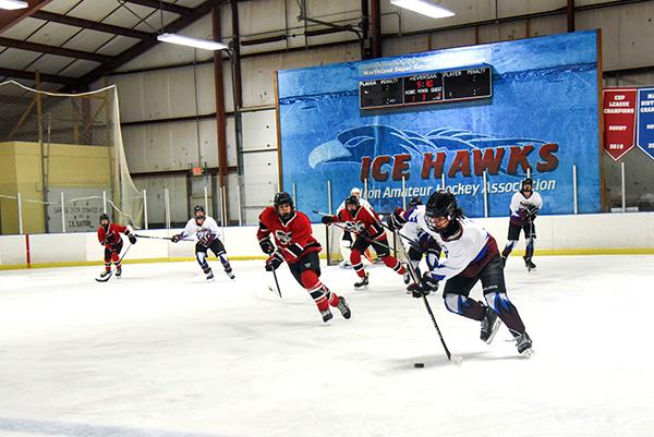 On Jan. 18 the Ice Hawks 16U Midget team played against Marquette team. Pictured are, from left, Johah Nelson #26, Domincik Brunswick #7 (skating with the puck) and Carson Sanregret #2. 