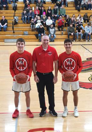 Recently, Forest Park Seniors Felix Quevedo (right) and Gaven Rintala were presented game balls by their Coach Jason Price. Rintala set a Forest Park School record for three pointers in one game with 11 while Felix Quevedo set a record for most steals in a game in the State of Michigan with 15. (Submitted photo.)