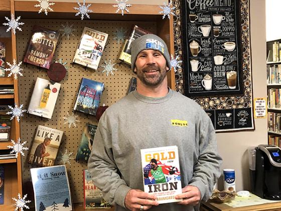 2022 Olympic Gold Medalist and Iron River resident, Nick Baumgartner with his inspirational book, Gold from Iron, at the West Iron District Library.