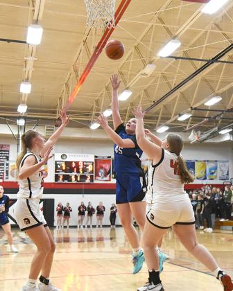 WIC junior, Sidney Storti #45 pushed through two Forest Park defenders to get her shot at the basket.