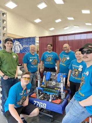 Members of the Automatons stand with their robot, for which the team received the Autonomous Award at the Escanaba District Event in Escanaba. Pictured are, (standing) Evan Thibodeau, Ray Guzowski, Jeff Davis, Van Hill, Bri Porier and Brennon Gursky; (kneeling) Cooper Hill. (Submitted photo.)
