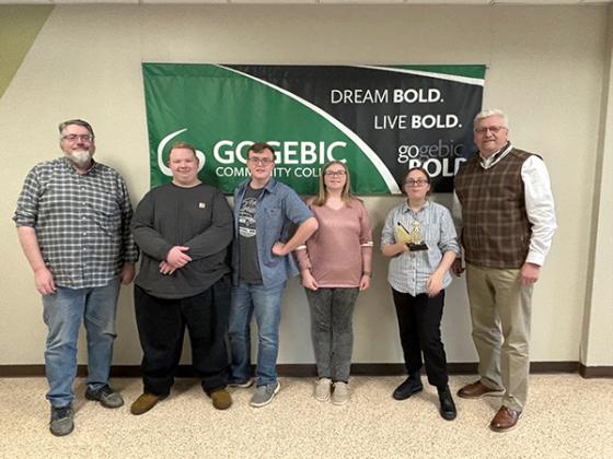The West Iron County I High School Quiz Bowl Team took runner up honors at the Gogebic Community College Annual Spring Invitational Tournament. Pictured are, from left, Coach Joel Van Lanen, Rockey Farley, Jayden Mcwethy, Abby Farley and Rachel Fanous (team captain) receiving the winning trophy from GCC President, Chris Patritto.