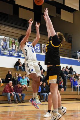 Up and over! WIC junior, Abel Lundin #5 shoots over the Gwinn defenders.